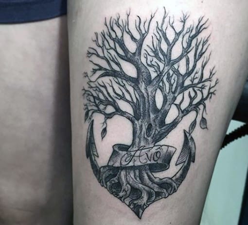 Tattoo of a leafless tree growing from an anchor with a ribbon reading 'Avo' elegantly wrapped around