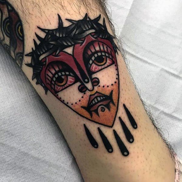 Bold heart-shaped tattoo featuring a surreal face with expressive eyes, dramatic makeup, and dripping black teardrops