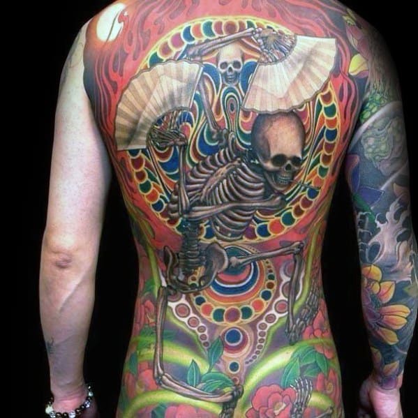 Vibrant full-back tattoo featuring a dancing skeleton with fans, surrounded by psychedelic patterns, flames, and bold colors for a striking design.