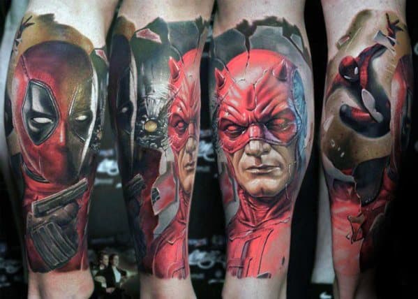 Full sleeve tattoo featuring hyper-realistic portraits of Deadpool, Daredevil, and Spider-Man with dramatic shading and cracked effects.