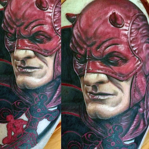 Close-up Daredevil tattoo with intense realism, textured red suit, and subtle details of rope and a mini Daredevil figure in action.