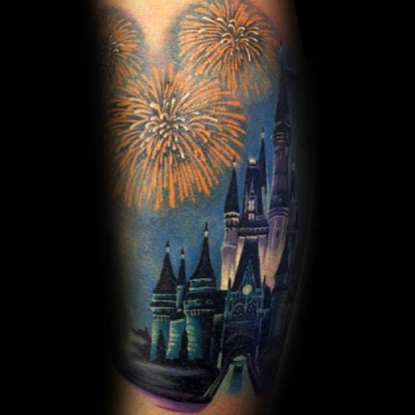 Tattoo of a magical castle at night with golden fireworks lighting up the sky, featuring rich shading and vibrant colors for a fantasy-inspired design.