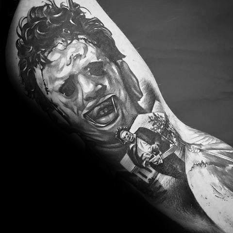 Black and grey tattoo of Leatherface from *The Texas Chainsaw Massacre*, featuring his grotesque mask and a chilling scene with his chainsaw.