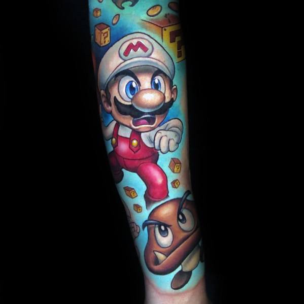 Vibrant *Super Mario* tattoo featuring Fire Mario in mid-action, with a Goomba, question blocks, and dynamic shading for a bold gaming-inspired design.