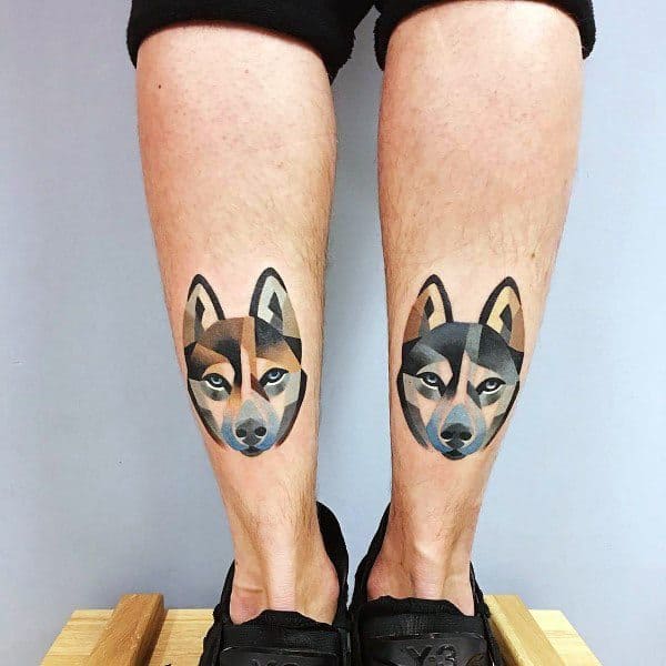 Modern geometric Siberian Husky tattoos on both legs, featuring bold shapes, soft shading, and a symmetrical design for a contemporary aesthetic.