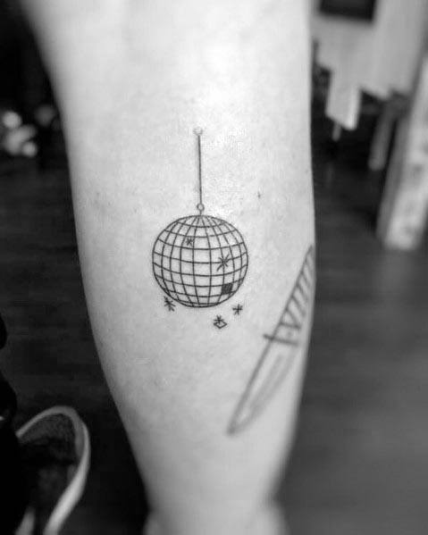 Minimalist disco ball tattoo with fine line details and sparkles, hanging elegantly for a simple yet stylish retro-inspired design.