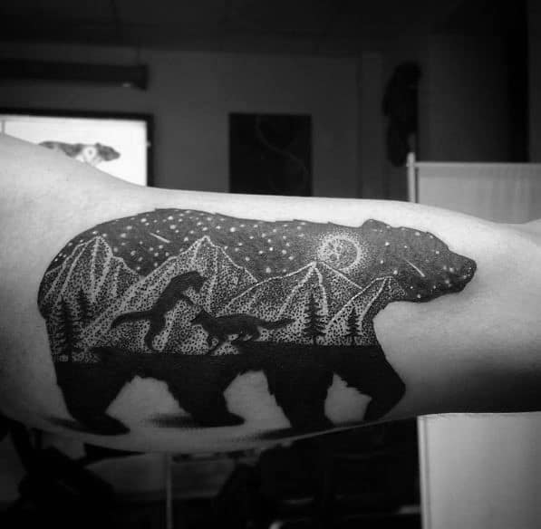 Dotwork tattoo of a bear silhouette filled with a night mountain scene, featuring dinosaurs, stars, and a crescent moon for a prehistoric vibe.