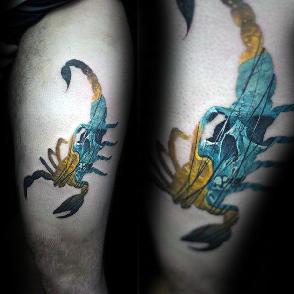 Colorful tattoo of a scorpion with a skull and desert canyon scene blended into its body, symbolizing danger, mystery, and survival.