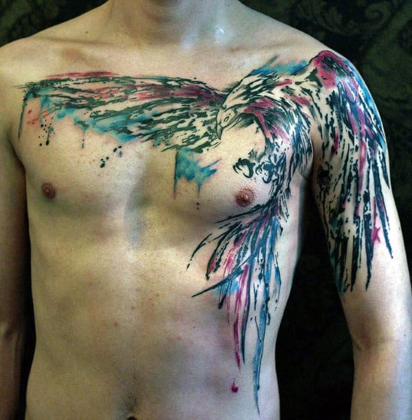 A person with a colorful, abstract bird tattoo across their chest and shoulder
