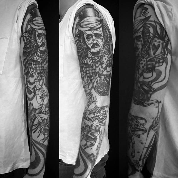Full black and grey sleeve tattoo featuring a surreal Edgar Allan Poe with a top hat, abstract patterns, a heart card, and eerie symbols.