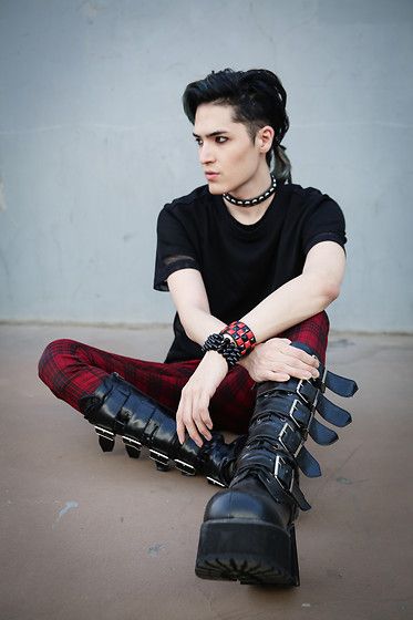 Man wearing combat boots with large black buckles