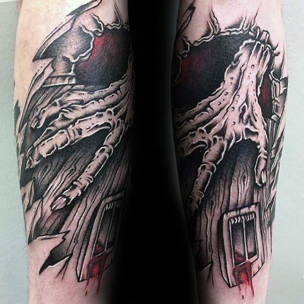 Dark and intense Evil Dead tattoo of a skeletal hand ripping through wood, revealing a demonic skull face above a blood-dripping cabin door