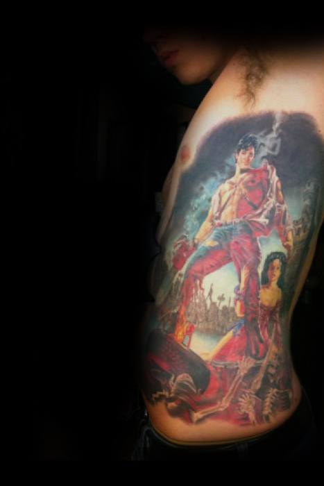 Epic full-side Evil Dead tattoo of Ash standing heroically with chainsaw and shotgun over a chaotic battlefield, surrounded by skeletons and a woman at his side, inspired by the *Army of Darkness* movie poster.