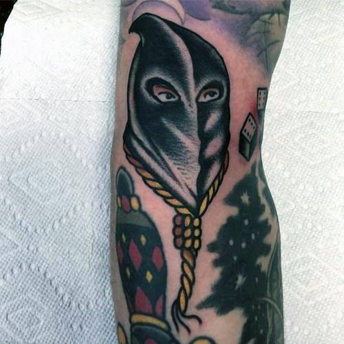 Executioner tattoo featuring a hooded figure with intense eyes, a hanging noose around the neck, and bold shading for a dramatic effect.