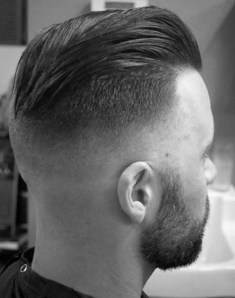Sleek, slicked-back top with a high skin fade on the sides and back