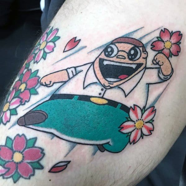 Tattoo of Peter Griffin from Family Guy in an exaggerated, anime-style pose, mid-air with a dynamic expression, surrounded by colorful flowers.