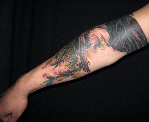 Forearm tattoo of an eagle in flight with vibrant colors and dark background