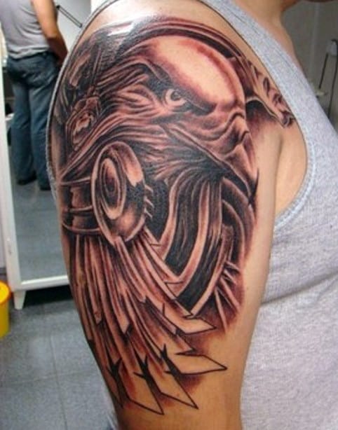 Detailed mechanical tattoo on upper arm and shoulder