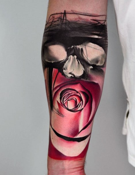 Tattoo of a skull above a red rose on a forearm