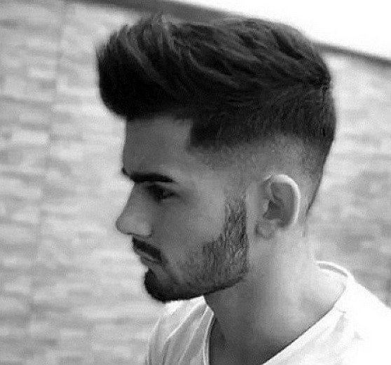 Voluminous faux hawk with a high fade on the sides and back