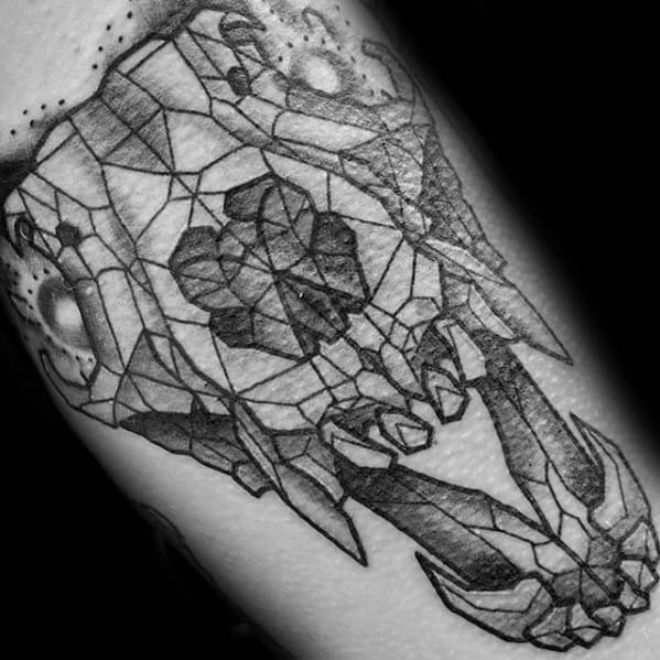 Geometric tattoo of a fox skull with a faceted, crystal-like design and bold black linework for a modern abstract look.