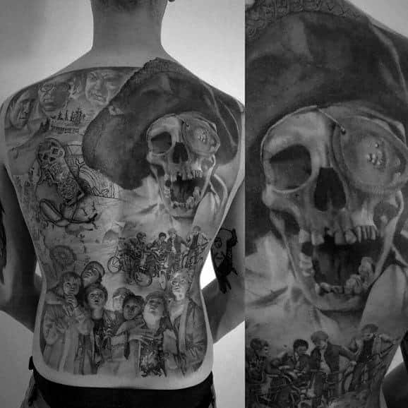 Black and gray full-back tattoo inspired by The Goonies, featuring One-Eyed Willy, the main characters, a treasure map, and adventure scenes.