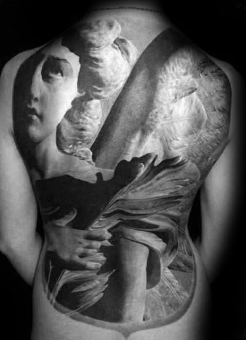A large black and grey tattoo covering the back, featuring an angel in a dynamic pose, with intricate details on the wings and flowing robes, and a serene face.