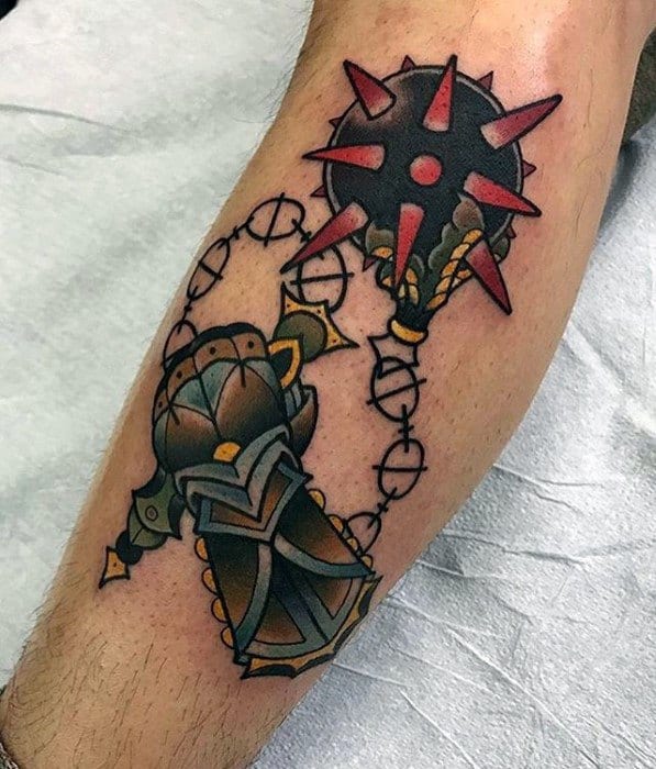 Colorful tattoo of a detailed armored gauntlet wielding a red spiked flail with a chain, featuring bold outlines and dynamic motion.