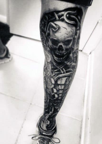 Leg tattoo showcasing a skull with intricate mechanical designs