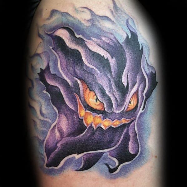 Haunting Haunter tattoo with swirling, smoky textures, glowing yellow eyes, and jagged grin, creating a ghostly, ethereal effect.