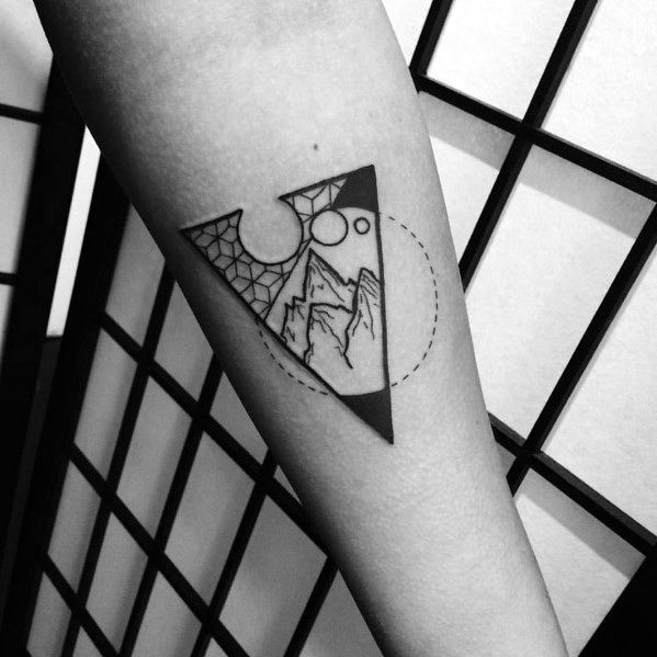 Creative geometric tattoo of a triangle with mountains, circular sun and moon, and web-like pattern inside a dotted circle frame.