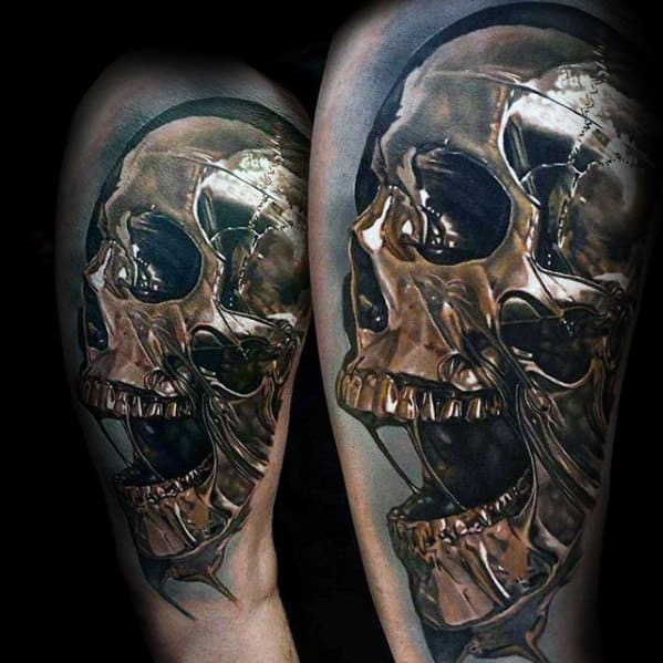 Realistic tattoo of an open-mouthed metallic skull on an arm, with dark shading and reflective details