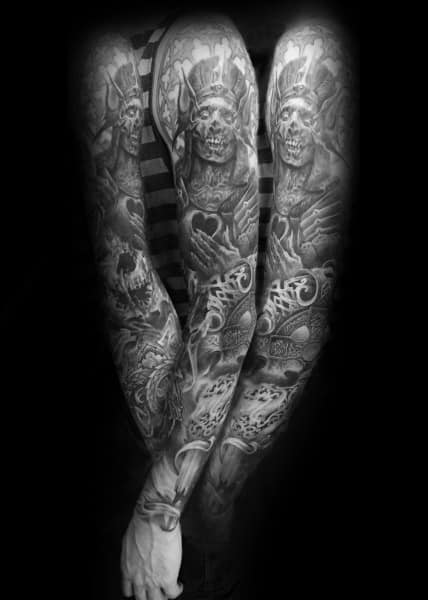 Gothic sleeve tattoo featuring skeletal kings with crowns, intricate patterns, and dark shading for a haunting and regal aesthetic.