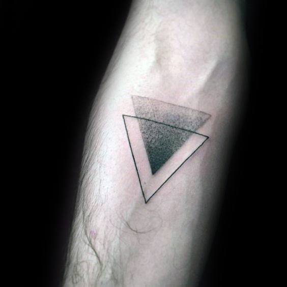 Minimalist tattoo of two overlapping inverted triangles, one outlined and one filled with a black dotwork gradient fading upward.