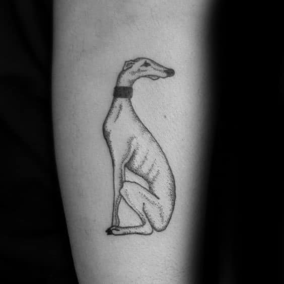 A simple and elegant black ink tattoo of a greyhound in a seated pose, with fine detailing and shading to highlight its graceful form.