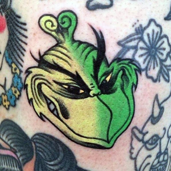 Grinch face with a mischievous grin and vibrant green color, featuring detailed features and bold lines for a playful and expressive tattoo design.