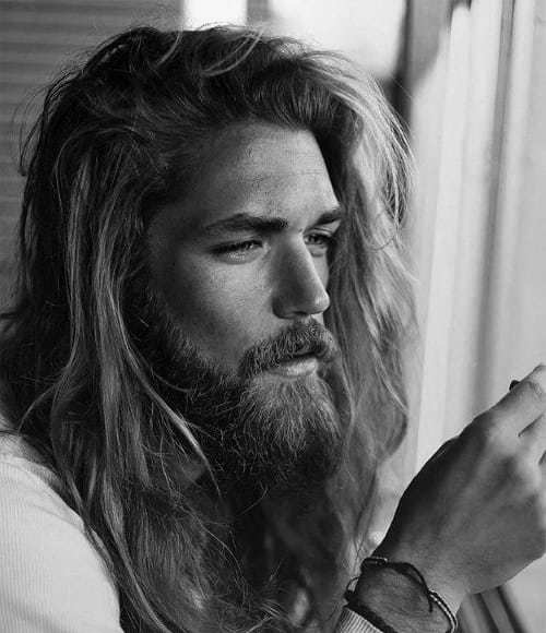 Man with long, wavy hair and a full beard