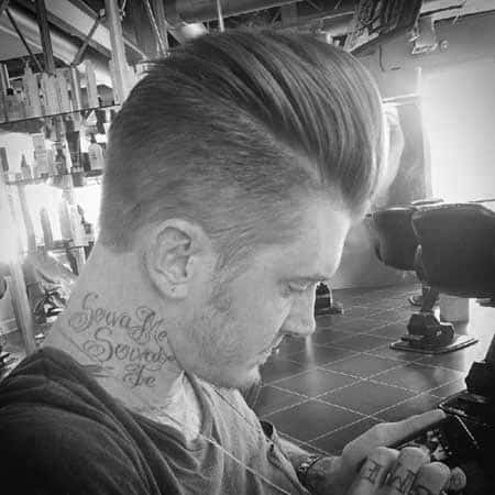 High-volume pompadour with a sharp side part and a clean fade