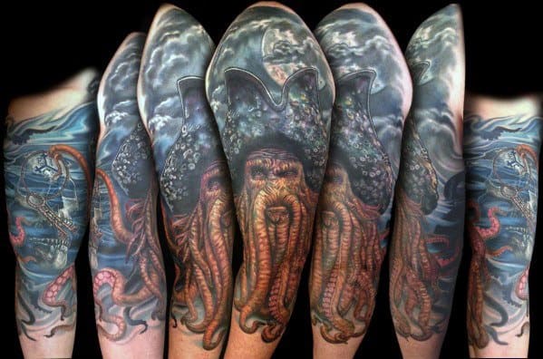 Epic full-sleeve Davy Jones tattoo showcasing his iconic tentacled face, deep-sea elements, and ominous maritime scenes for a dramatic and immersive design