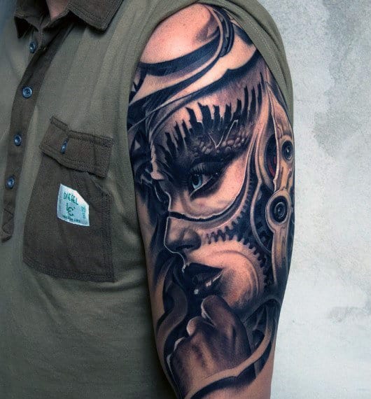 Detailed cyberpunk-themed tattoo on a person's upper arm and shoulder