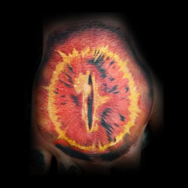 This hand tattoo, inspired by the Eye of Sauron, features a fiery design with a striking black vertical slit