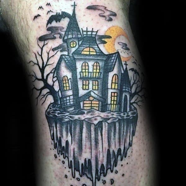 Colorful haunted house tattoo on a floating island with glowing windows, bare trees, bats, cloudy sky, and a yellow full moon.