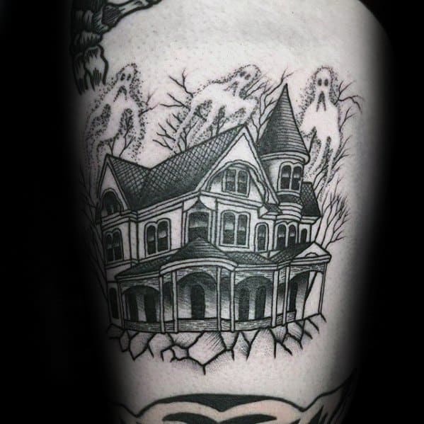 Linework tattoo of a haunted Victorian house with cracked ground, ghost figures floating above, and leafless trees in the background.