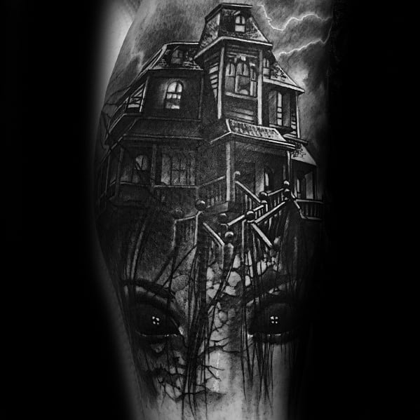 Haunted house tattoo with glowing windows and stormy sky, merging into a cracked face with intense eyes hidden beneath the structure.