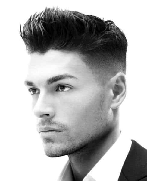 Voluminous, spiked top with a high fade on the sides and bac