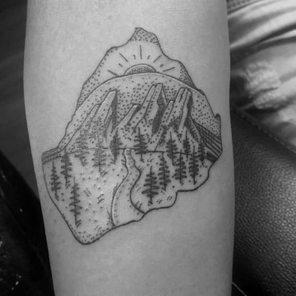 Minimalist dotwork tattoo of mountains, pine trees, and a rising sun, symbolizing adventure, nature, and the great outdoors.
