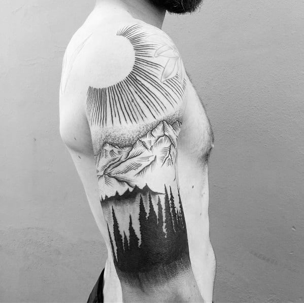 Black and white nature-themed tattoo featuring a sun, mountains, and a dense pine forest, symbolizing adventure and the great outdoors.