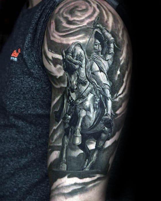 Detailed black and grey tattoo of a warrior on horseback with a bow, set against a swirling cloud or smoke background on the upper arm