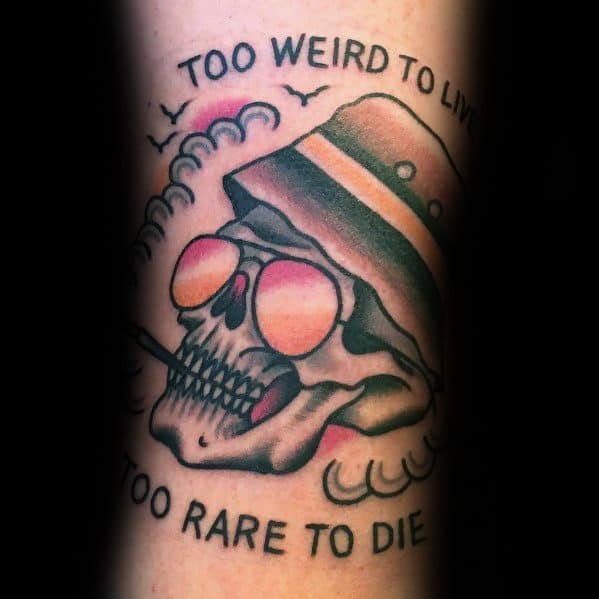 Hunter S. Thompson-inspired tattoo featuring a skull with aviator glasses, a bucket hat, a cigarette, and the quote "Too Weird to Live, Too Rare to Die."