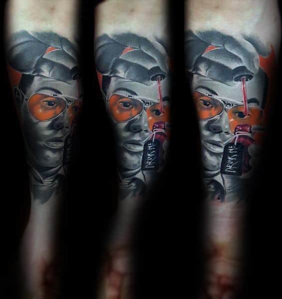 Hunter S. Thompson-inspired tattoo featuring a surreal black and gray portrait with orange-tinted aviator glasses, a bucket hat, and a "Drink Me" bottle.